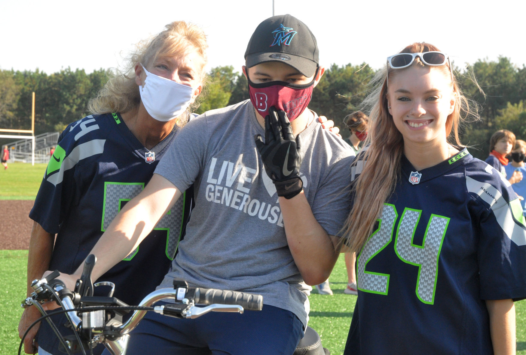 Badger High School student Brooks Guif, center, is surrounded by his mother, Sue Guif, and sister, Ashley Guif